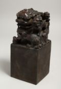A LARGE CHINESE BRONZE FOO DOG SQUARE SEAL 7.5ins high, 3ins square.