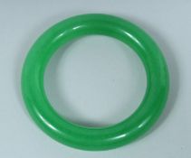 AN APPLE JADE CARVED BANGLE.