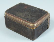 A GEORGIAN TORTOISESHELL BOX pressed decoration with musical trophies. 3ins long.