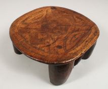 A CARVED AFRICAN STOOL. 8ins long.