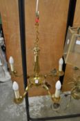 A brass five branch chandelier.