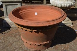 A large terracotta plant pot (lacking base).