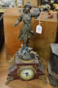 A decorative Victorian mantel clock with figural mount.