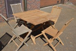 A square shaped folding hardwood garden table with four chairs.
