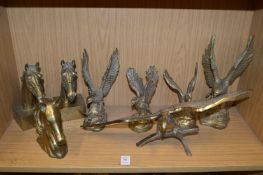 A quantity of cast brass ornaments of eagles and horses heads.