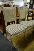A pair of distressed painted occasional chairs.