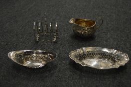 A silver cream jug, two bonbon dishes and a toast rack.