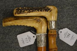 Two Victorian walking sticks with antler handles and silver collars.