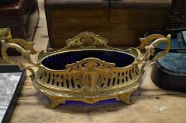 An ormolu jardiniere with blue glass liner.