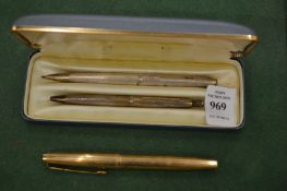 A cased silver pen and pencil set together with a fountain pen.