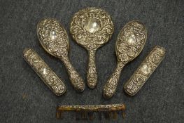 A five piece silver backed dressing table set.