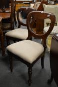 A pair of Victorian mahogany balloon back dining chairs.