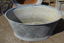 A large galvanised bath tub.
