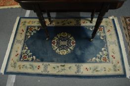 A Chinese blue ground rug 160cm x 95cm.