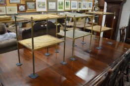 A pair of brass and leather two tier etageres together with a similar etagere.