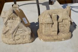 Two small garden ornaments modelled as houses.