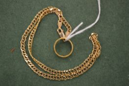 A gold wedding band and a gold chain.