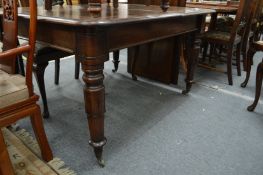 A good 19th century mahogany extending dining table with two leaves on carved and turned supports.