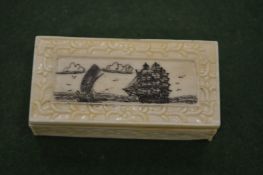 A small bone box with engraved hinged lid.
