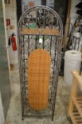 A floor standing wrought iron wine rack.