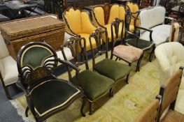 A late Victorian inlaid mahogany elbow chair together with a similar chair and three side chairs.(