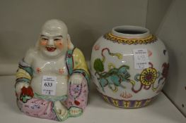 A colourful pottery model of a seated buddha and a colourful ginger jar.