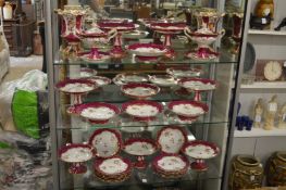 A very good comprehensive porcelain dessert service, white ground with crimson and gilt borders