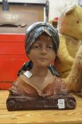 Plaster bust of a young girl.