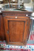 A 19th century oak hanging corner cupboard.
