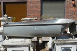 A large galvanised slipper bath/.