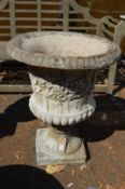 A large composite urn shaped garden planter.