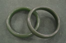 Two Chinese dark green jadeite bangles.
