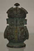 A small archaic bronze vase and cover.