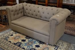A good early 20th century Chesterfield style two seater settee upholstered in a grey coloured