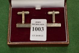 A pair of silver cufflinks.
