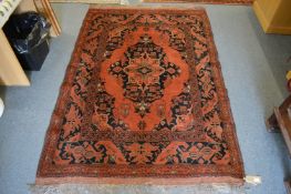 A Persian rug, crimson ground with central large motif 195cm x 132cm.