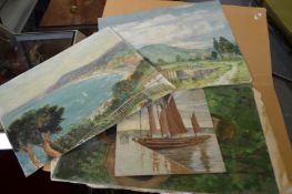 A group of unframed oil paintings.