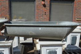 A large galvanised slipper bath.