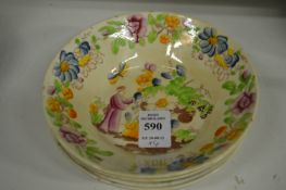 Four small colourfully decorated saucer dishes.