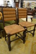A pair of rush seated dining chairs.