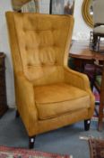 A good Georgian style gold velour upholstered button back wing armchair.
