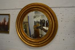 A large gilt framed circular wall mirror, 145cm diameter.