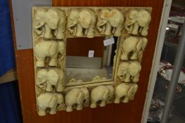 Decorative mirror, the frame with moulded elephant design.