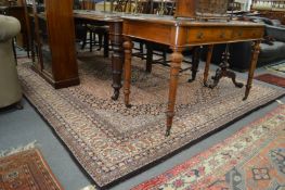 A large Persian style machine made carpet 350cm x 250cm.