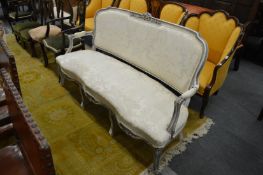 A French grey and cream painted settee upholstered in a cream ground classical fabric.