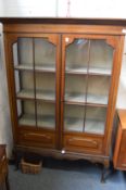 An Edwardian inlaid mahogany standing display cabinet.