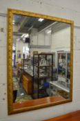 A large decorative gilt framed mirror.