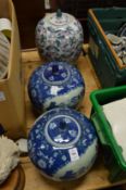 A pair of Chinese blue and white jars and covers and a similar jar.