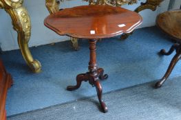 A mahogany tripod table.