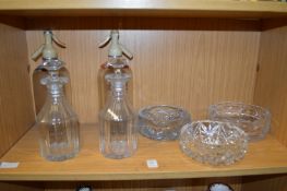 A pair of cut glass decanters and other items of glassware.
